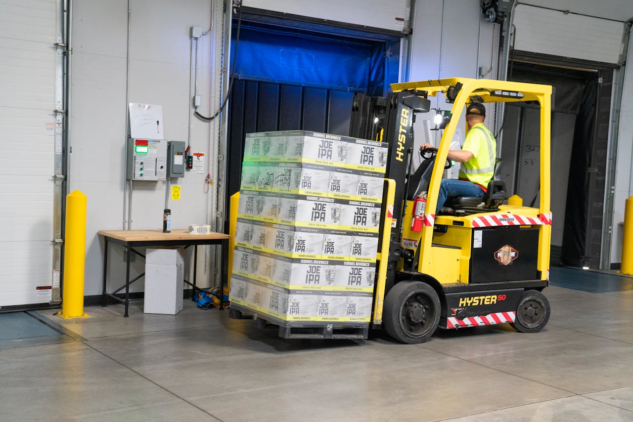 digital A warehouse employee operating a forklift to move stocked goods indoors. Perfect for industry and logistics visuals.