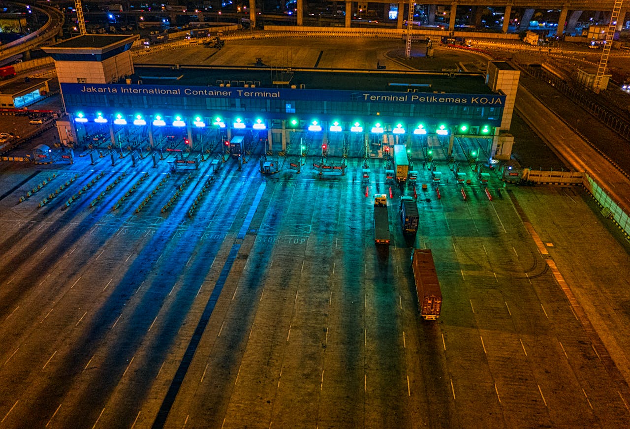 brand-03 Illuminated aerial view of Jakarta International Container Terminal highlighting logistics activity at night.